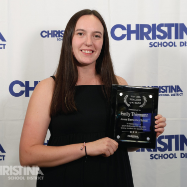 Photo of Emily Thiemann Jones ES Teacher of the Year holding plaque